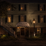 The historic 17Hundred90 Inn in Savannah, Georgia, glowing under gaslight at night, a famously haunted landmark featured on Savannah ghost tours and haunted Savannah walking tours.